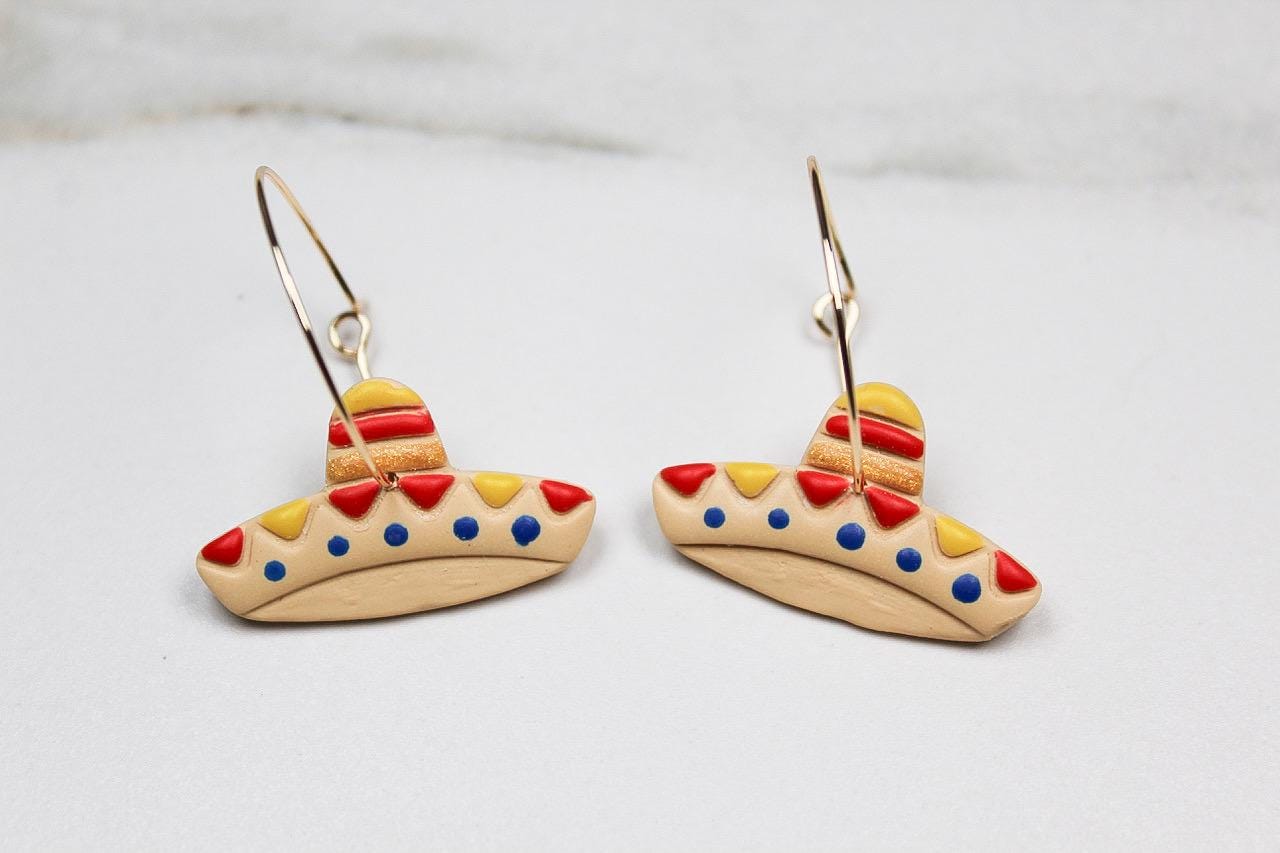 Colorful sombrero-shaped earrings on a white background