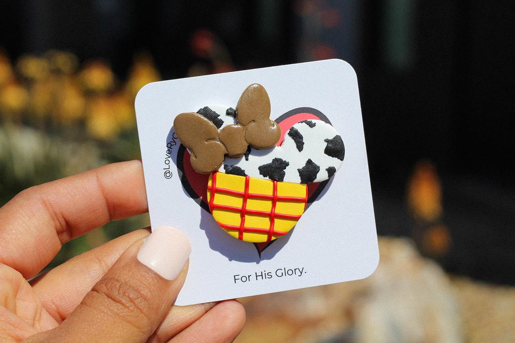 Card with a heart design featuring a textured mouse head and text held by a hand.