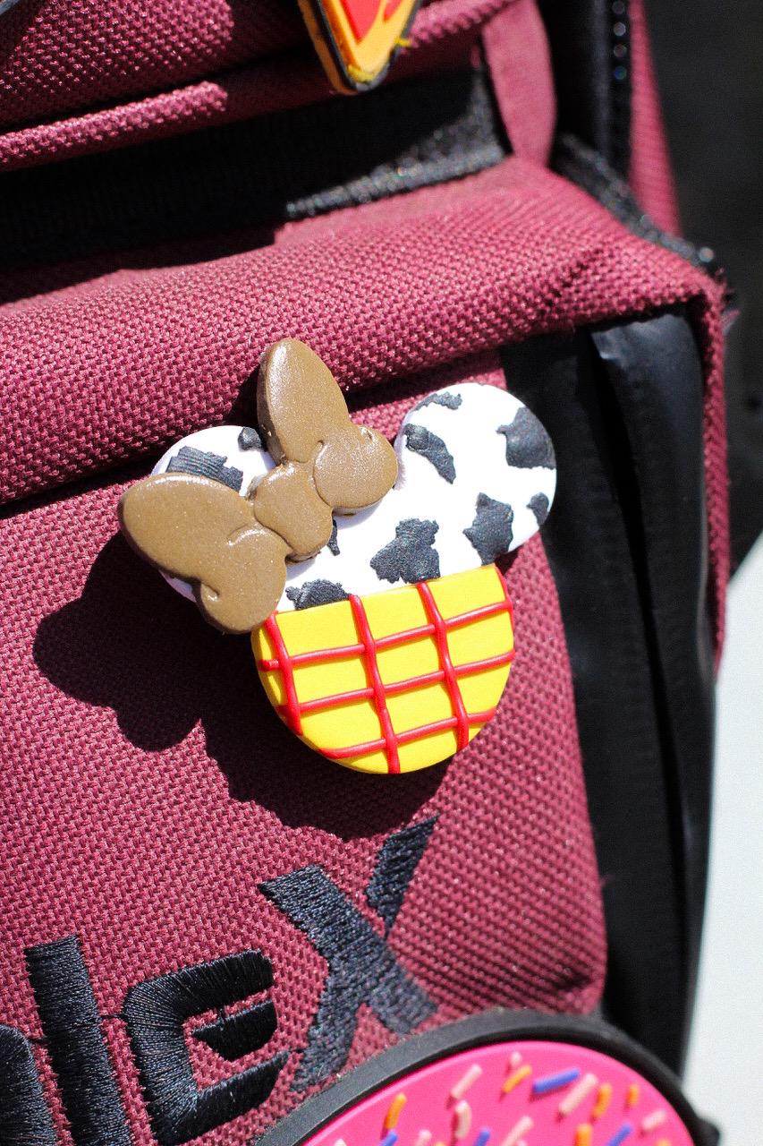 Textured mouse head with a bow on a red bag