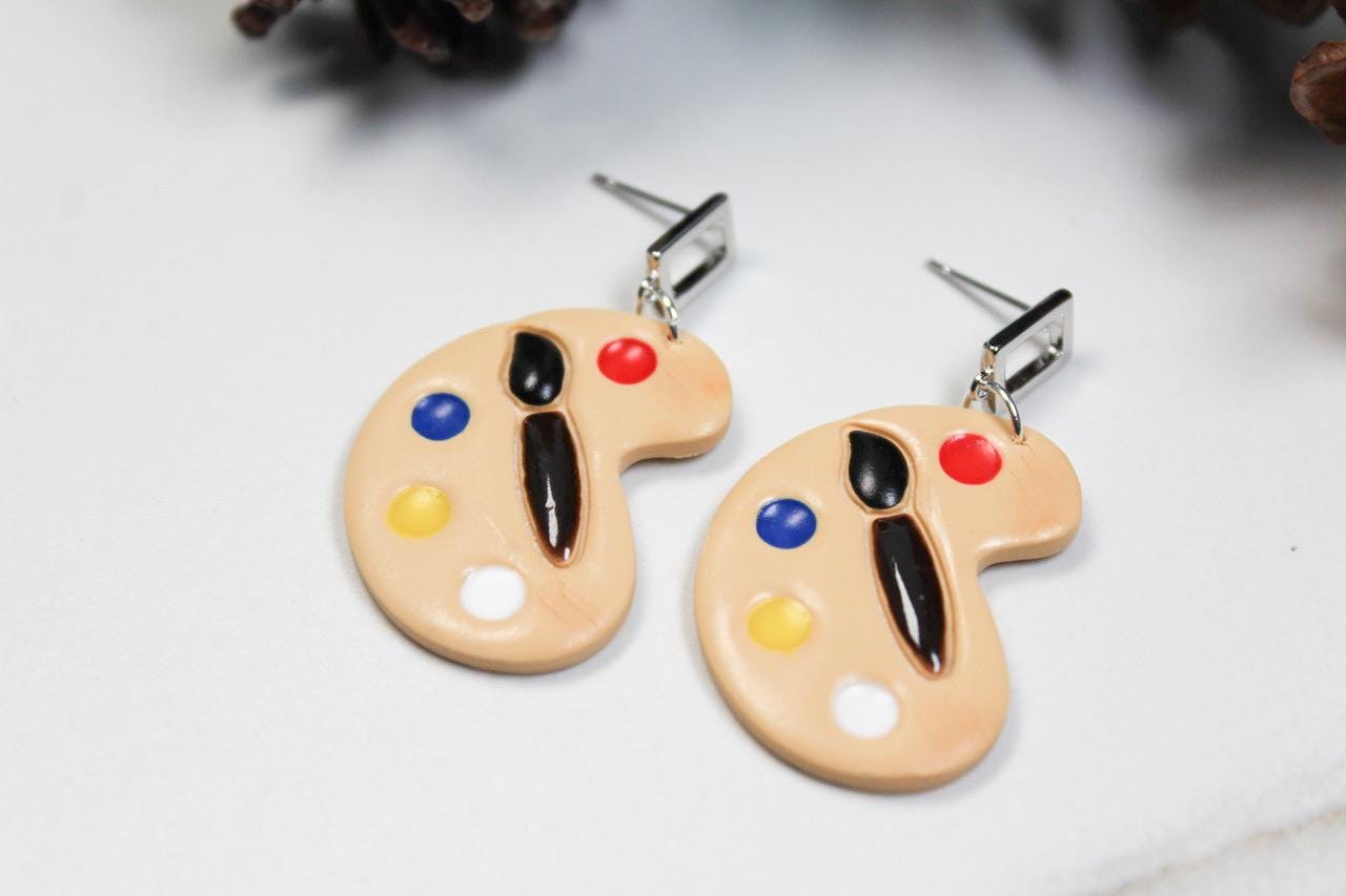 Pastry-shaped earrings with colorful design on a light background