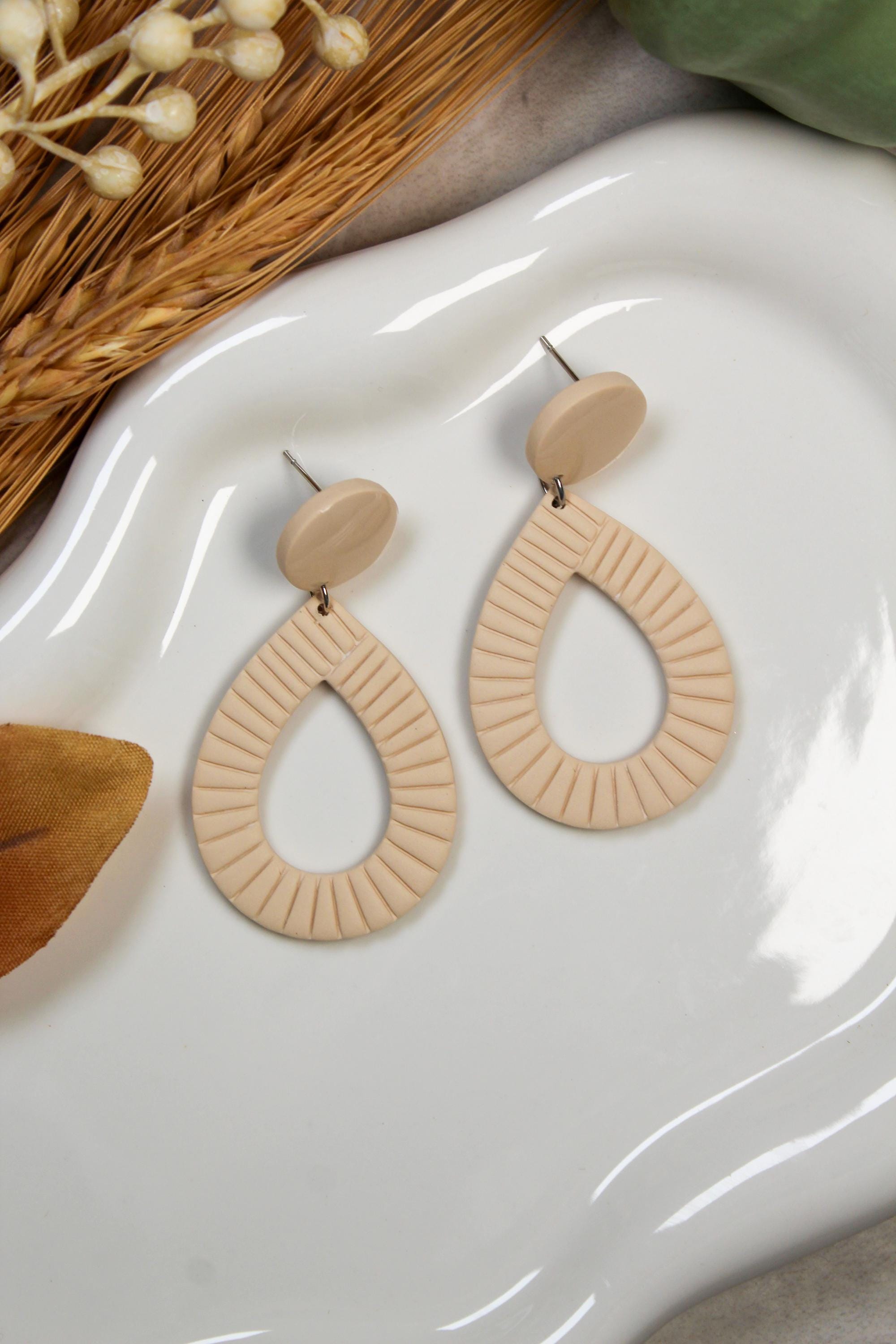 Ivory earrings on a white dish with decorative elements