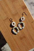 Decorative earrings on a wooden surface