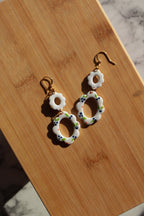 Decorative earrings on a wooden surface