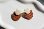 Pair of earrings with geometric design on a light background