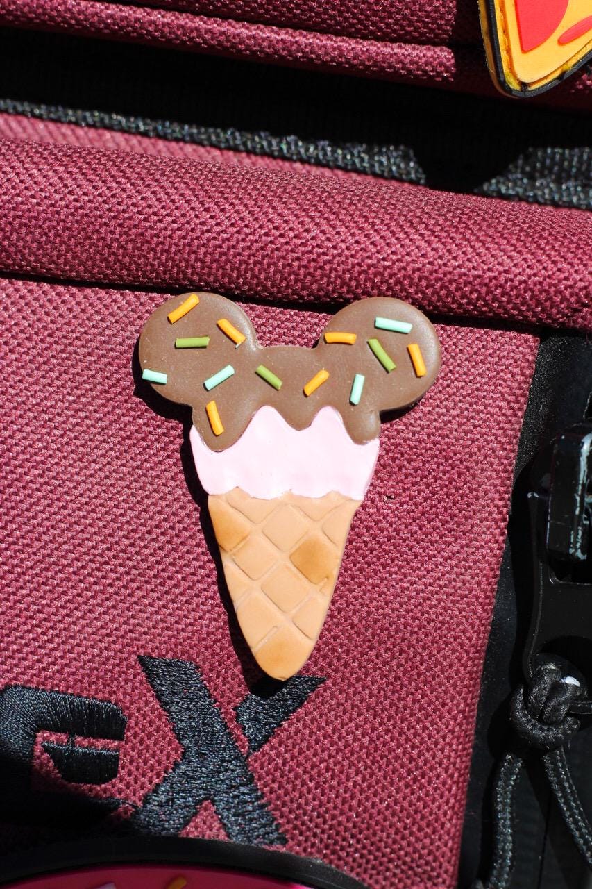 Ice cream cone pin on a red bag