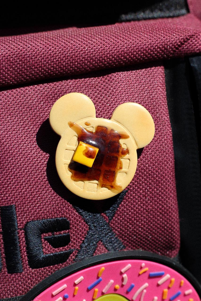 Close-up of a waffle pin with a brown center on a red bag