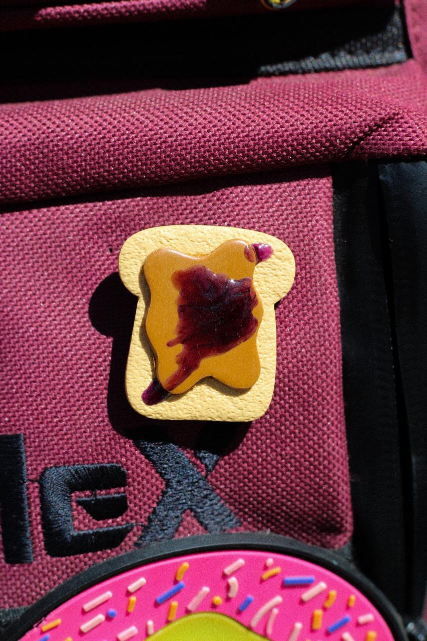 Pin of a toast on a red bag