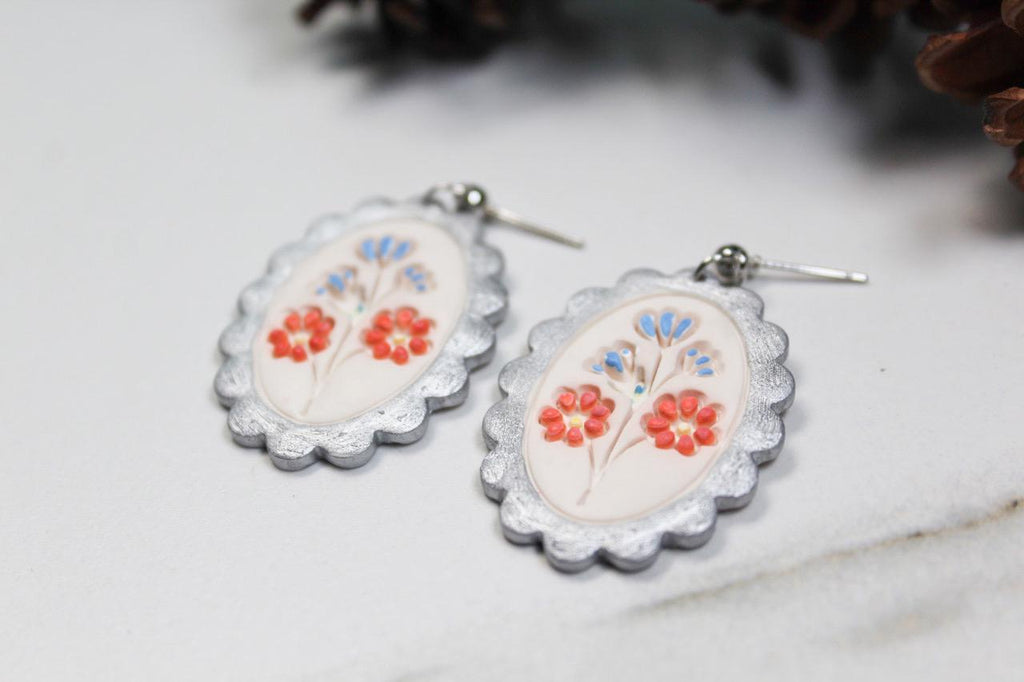 Pair of floral earrings on a light background