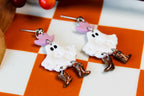 Ghost earrings with brown boots on a checkered background